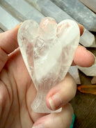 a one of a kind guardian angel hand-carved from natural clear quartz crystal to hold in meditation
