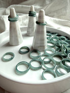Rounded Blue Water jade ring bands on display tray with stands, natural jadeite jewelry