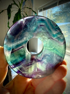 One of a kind rainbow fluorite donut crystal peace buckle, comes with a display stand