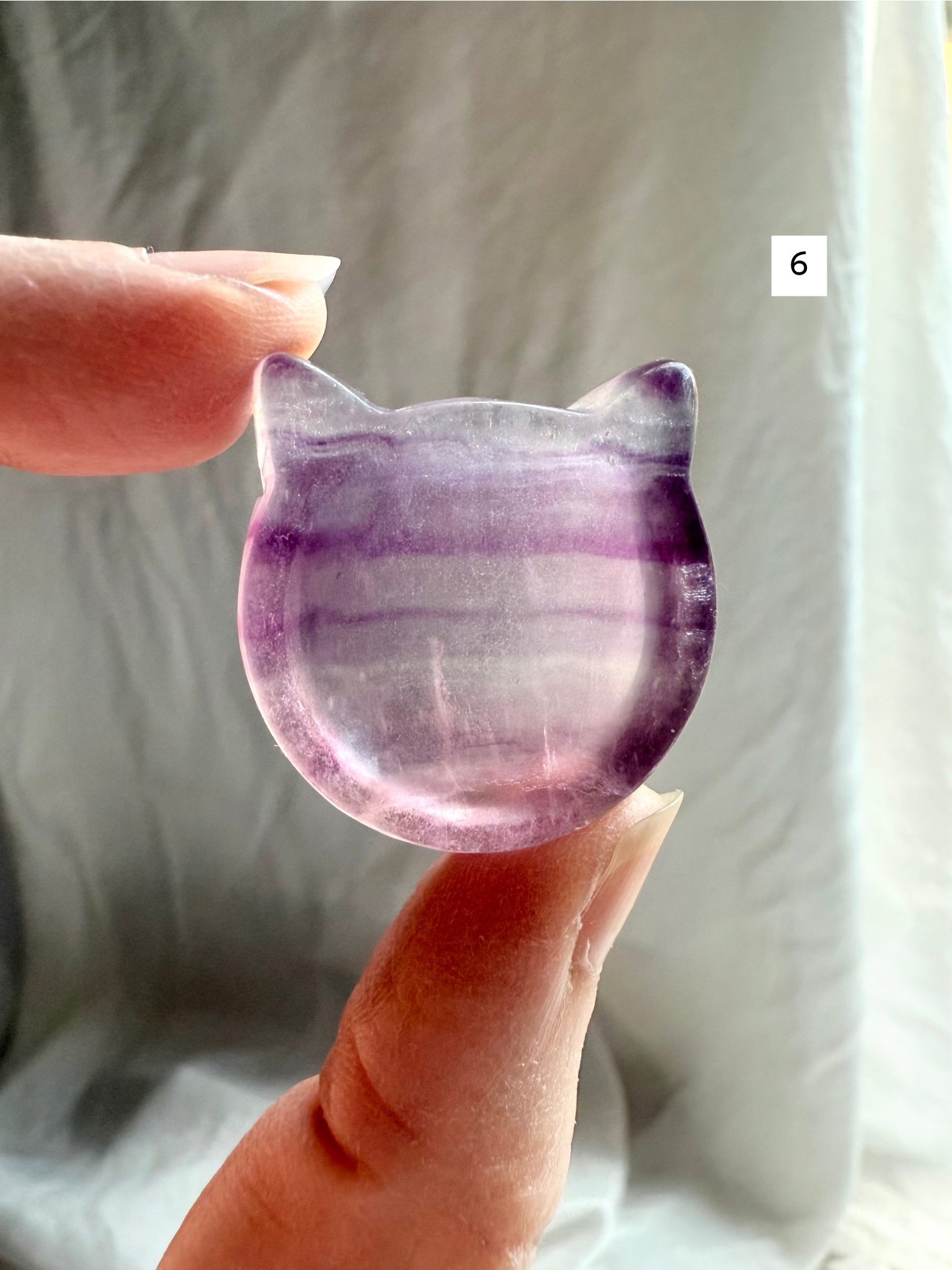 Fluorite cat-shaped crystal bowl held to the light – mini ring dish and jewelry holder