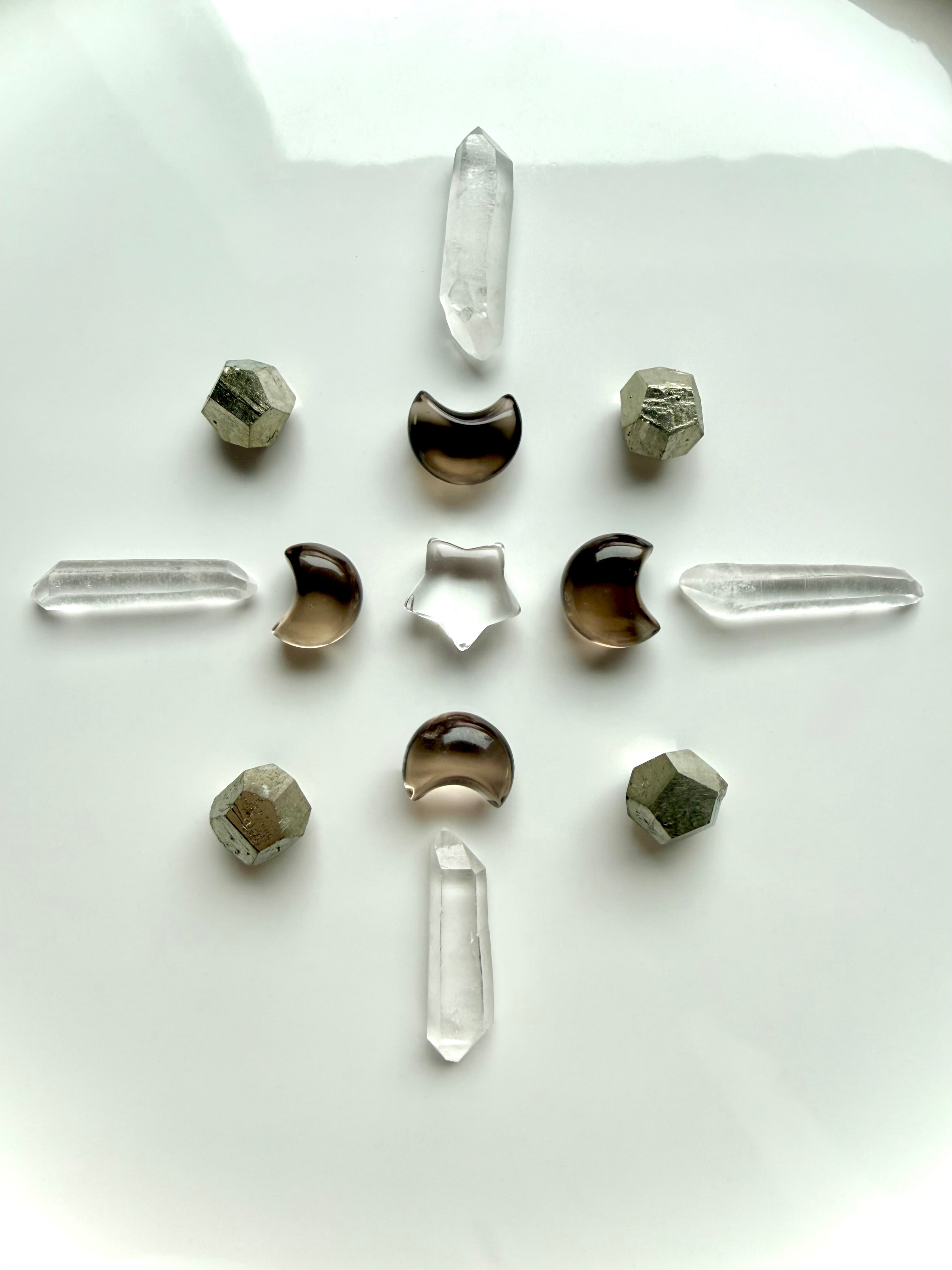 Celestial crystal grid with Smoky Quartz moons, Clear Quartz points and star, and geometric Pyrite crystals