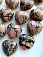 Rhodonite heart stones with unique pink and black patterns for self-love, compassion and Heart Chakra intentions