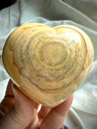 Polished Ocean Jasper heart with warm beige and cream orbicular patterns — unique collectible healing stone for grounding, love, and gentle balance.