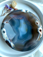 Close-up of Orca Agate offering bowl highlighting ocean-like blue layers and natural druzy details