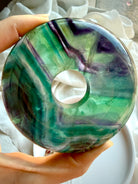 Close up of rainbow fluorite donut crystal peace buckle with glossy polish