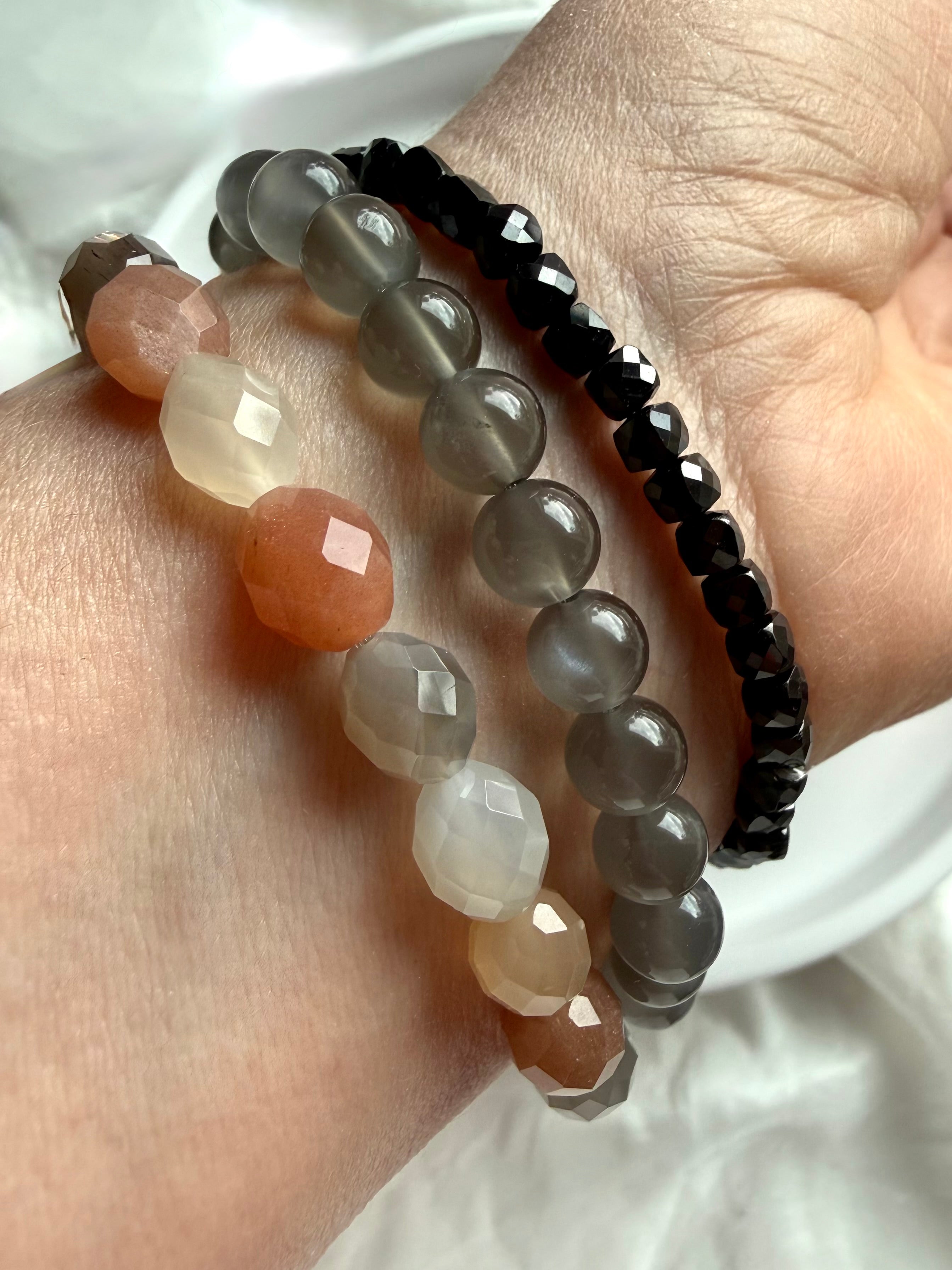 Faceted Moonstone bracelet stacked with Faceted Black Spinel and Black Moonstone bracelets, featuring sparkling gemstones and contrasting tones