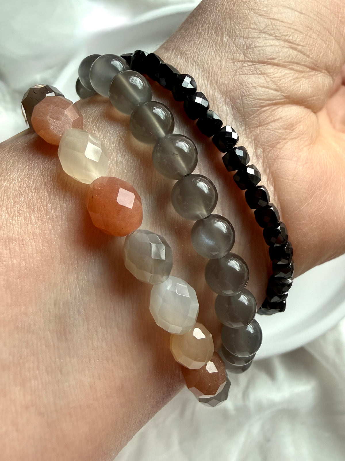 Faceted Moonstone bracelet stacked with Faceted Black Spinel and Black Moonstone bracelets, featuring sparkling gemstones and contrasting tones