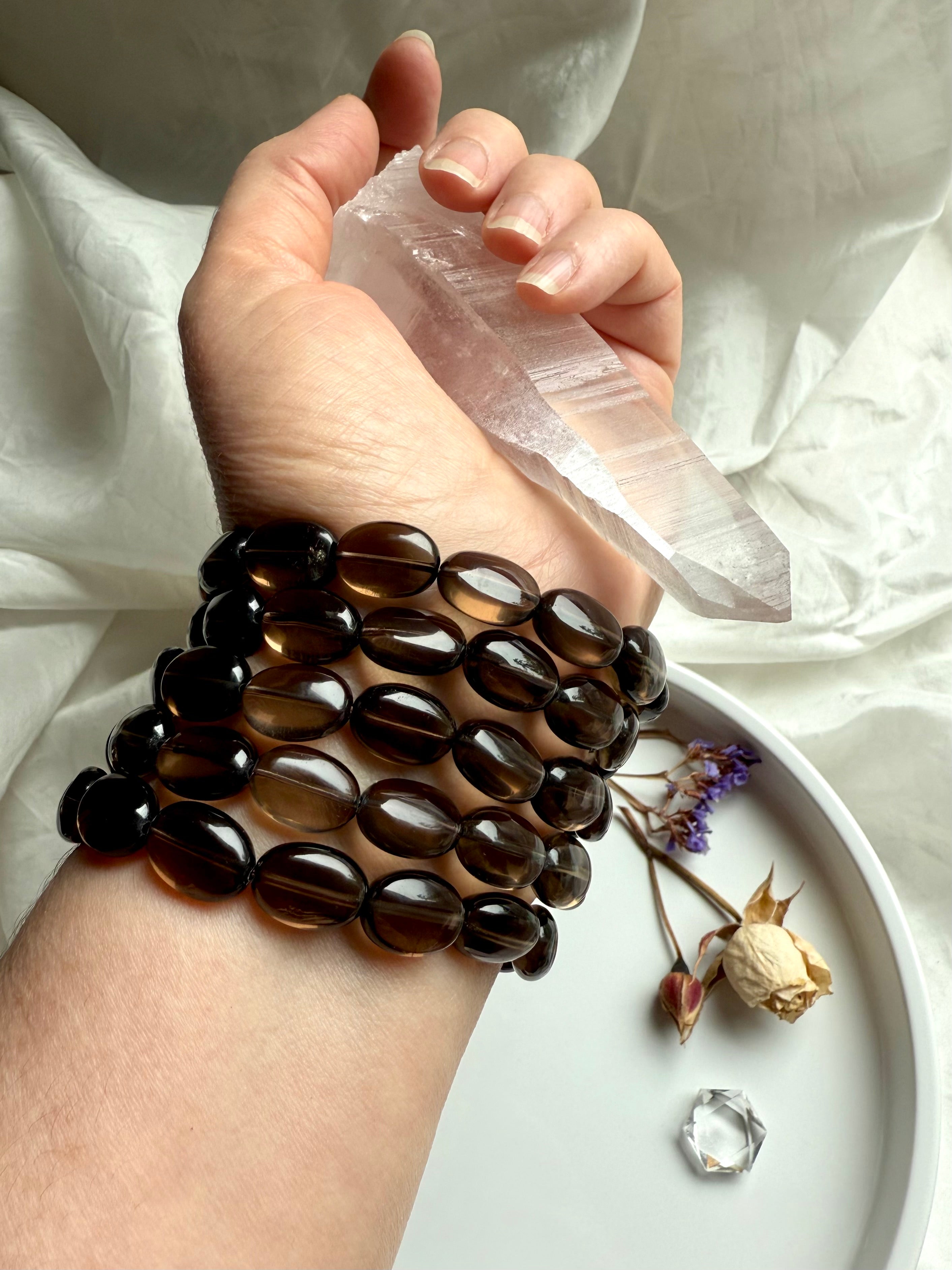 Smoky Quartz bracelets worn with Lemurian Quartz point – crystal jewelry for grounding and clarity
