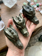 Pyrite crystal dragon carvings shown in hand, metallic gold pyrite stone for grounding, protection and abundance