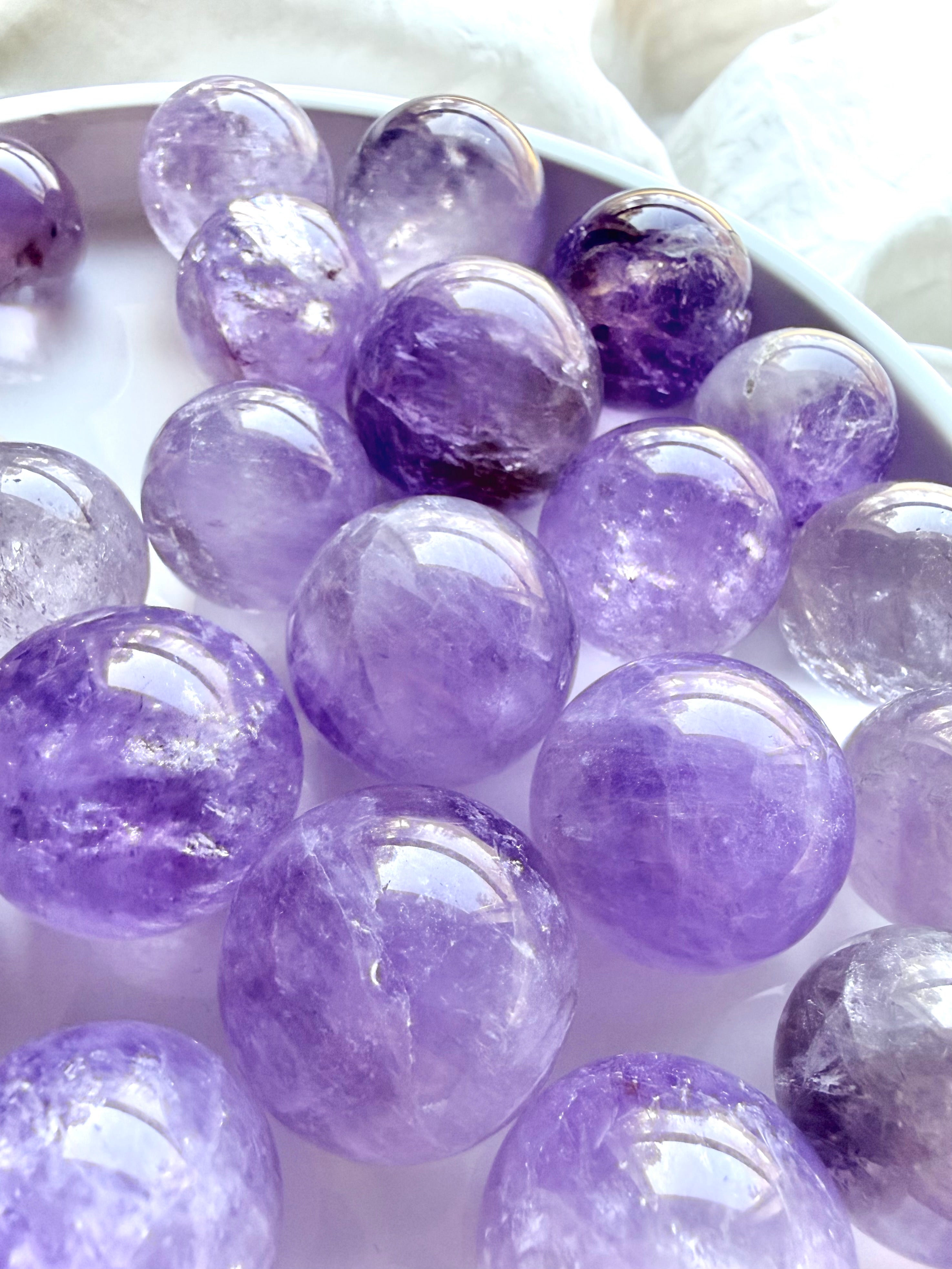 mini smoky amethyst spheres group showing natural variation in color and clarity
