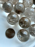 Collection of Smoky Quartz mini spheres with varied smoky tones and reflective polished surfaces