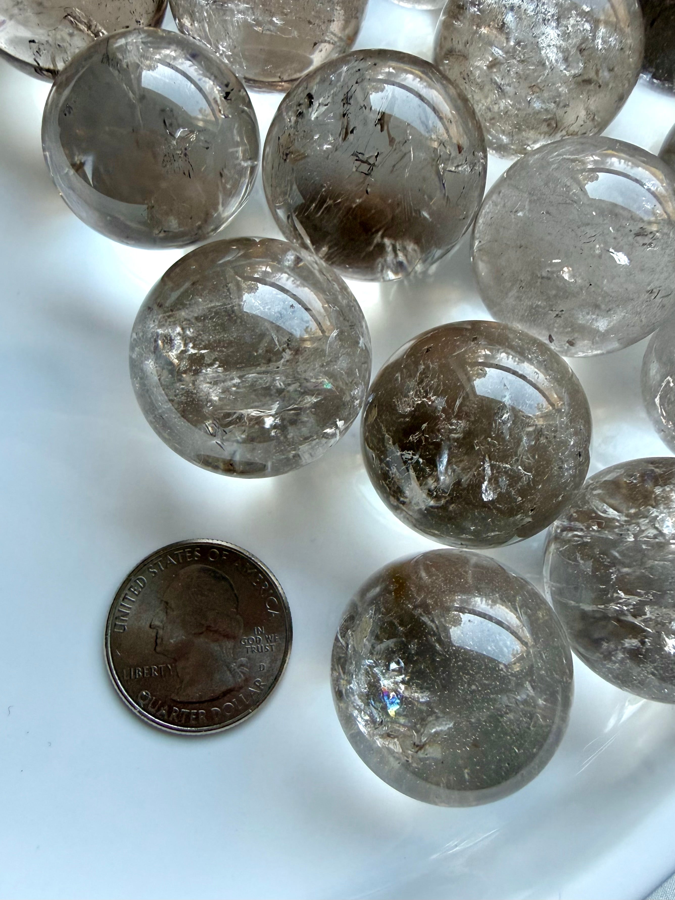 Collection of Smoky Quartz mini spheres with varied smoky tones and reflective polished surfaces