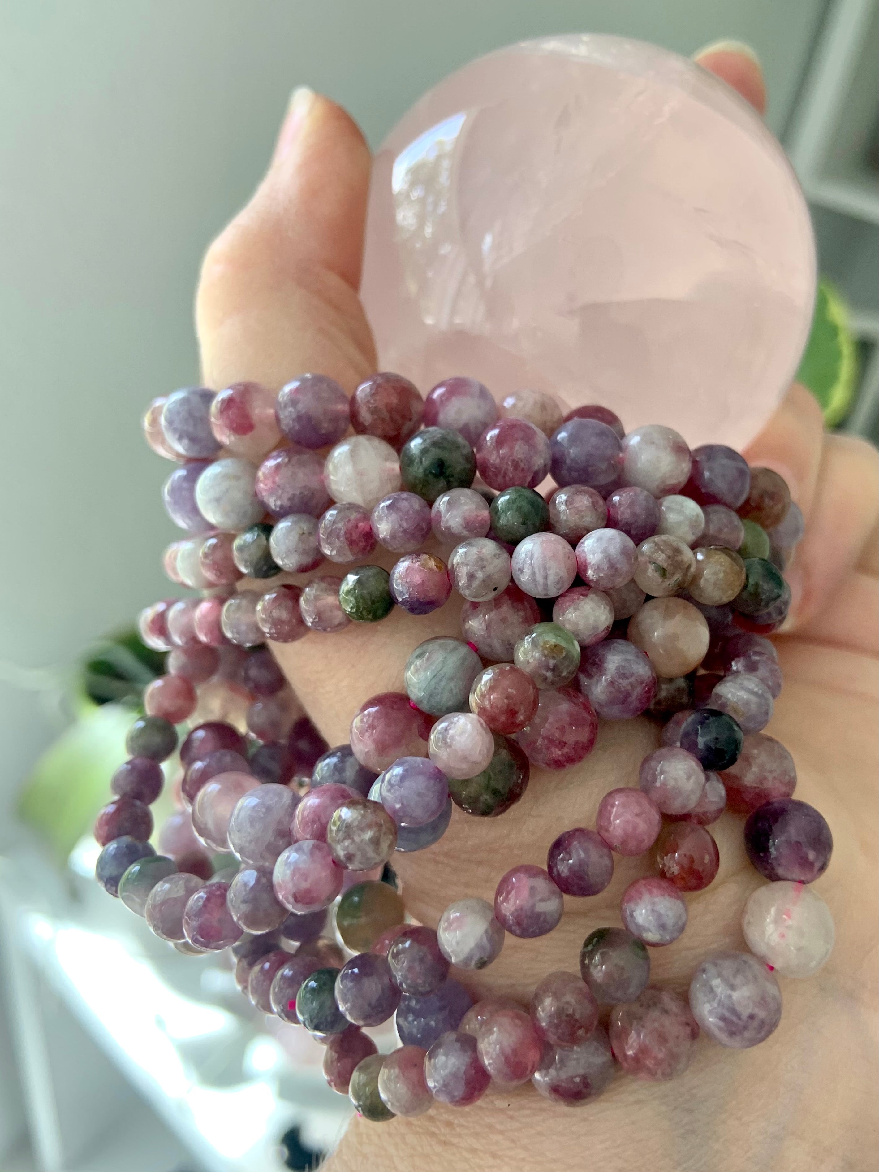 Heart chakra crystal stack with Watermelon Tourmaline & Lepidolite bracelets and rose quartz sphere — calming stones for emotional healing + self-love