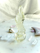 Citrine Quan Yin statue arranged in an altar display with clear quartz points, pearls, and crystal moons for abundance and positivity