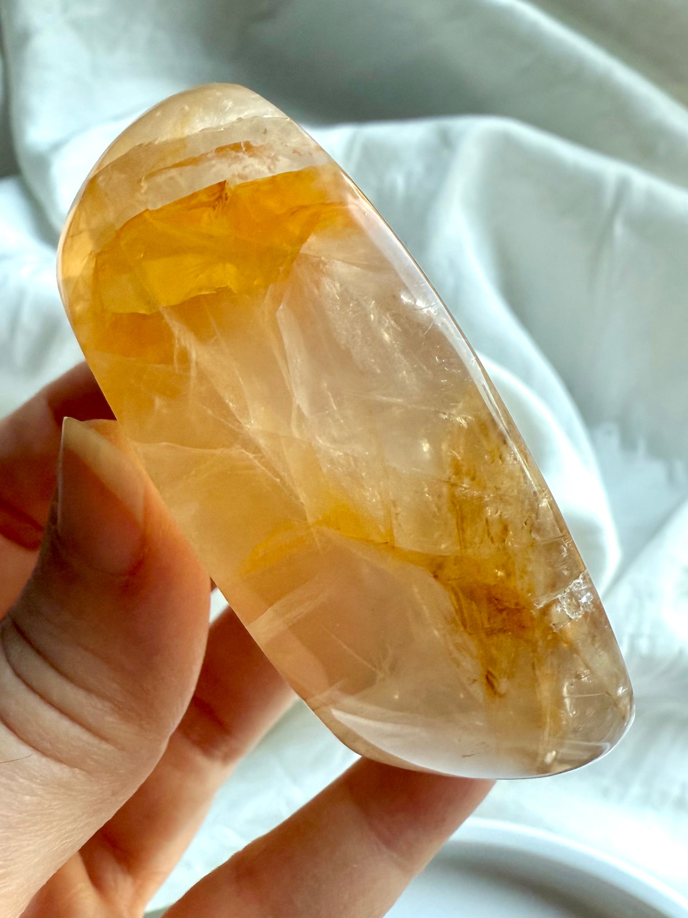 Small Golden Healer Quartz bowl in hand showing depth, clarity, and golden hematite inclusions