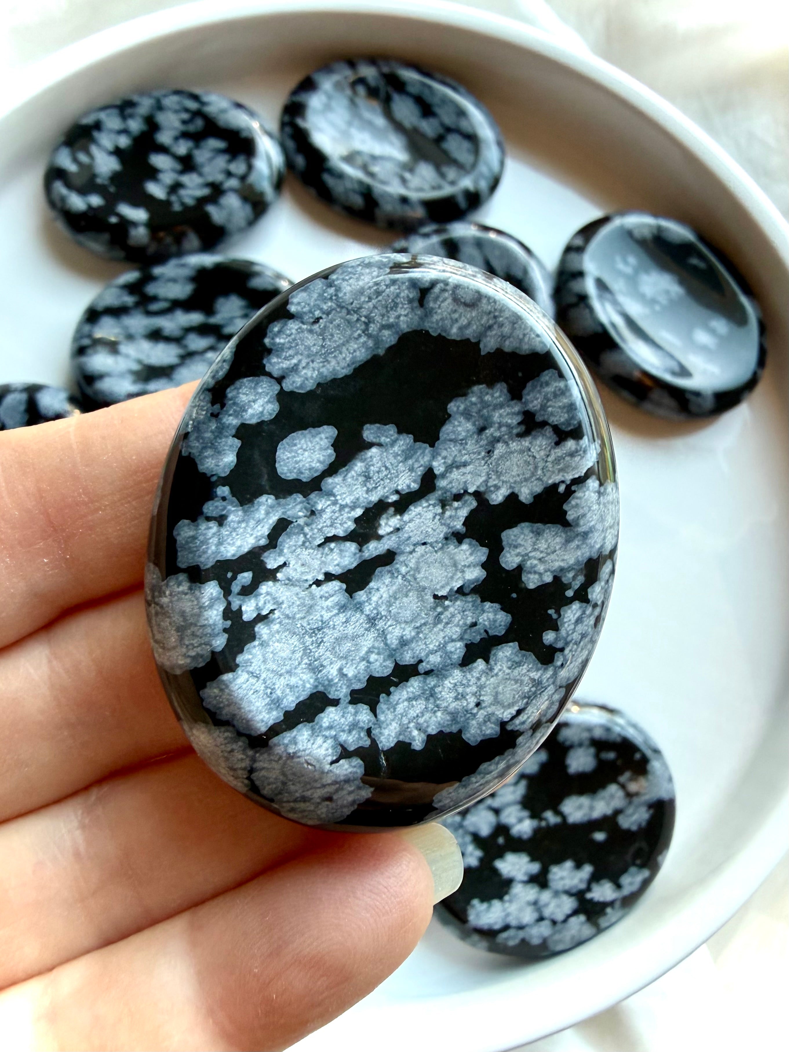 Snowflake Obsidian worry stone close-up showing silver snowflake crystal patterns for grounding and anxiety relief