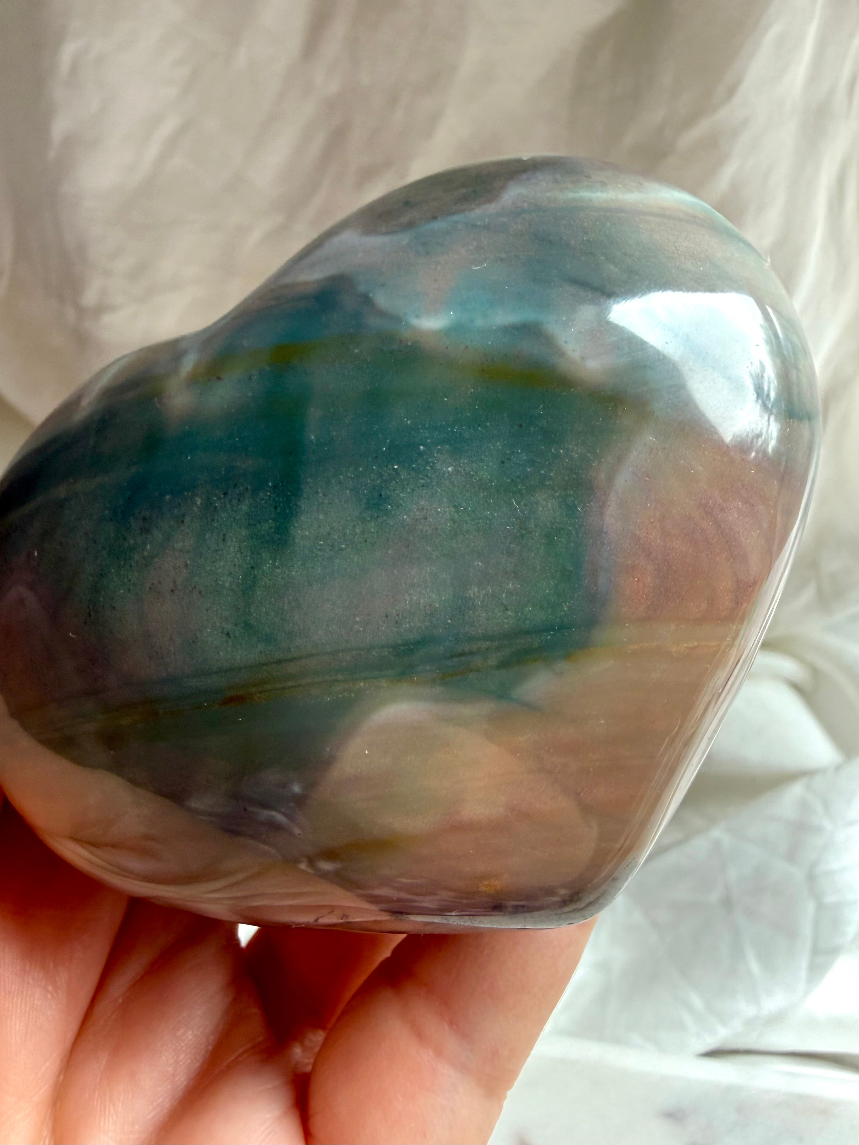 Handheld Ocean Jasper crystal heart with smooth curved shape and layered teal and mauve patterns