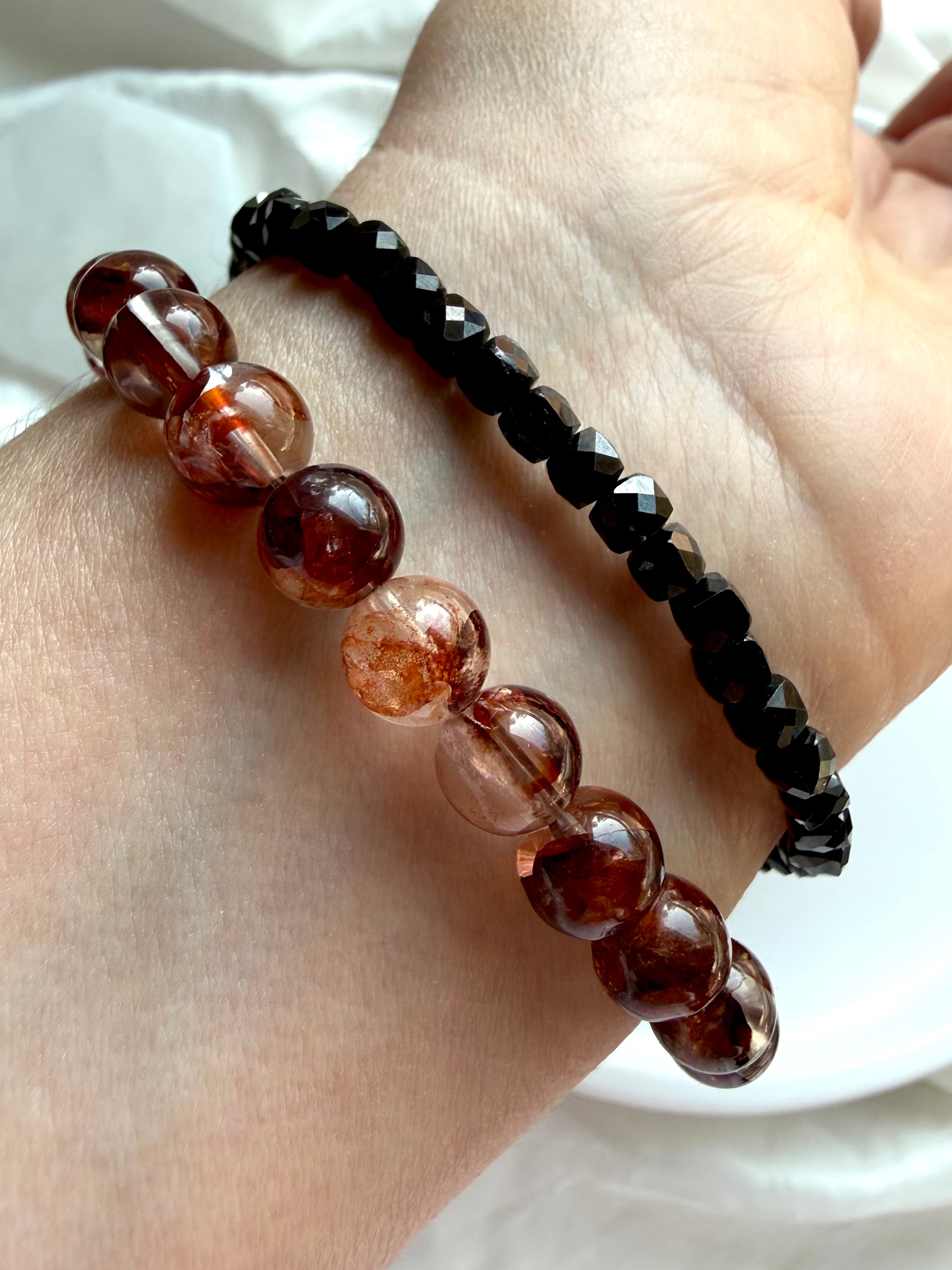 Fire Quartz bracelet stacked with a Faceted Black Spinel bracelet for crystal jewelry styling, Root Chakra crystals for grounding and vitality