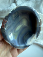 Orca Agate bowl interior with dramatic black, grey, and cream banding — smooth hand-carved crystal bowl for offerings, intention setting, and energy cleansing.