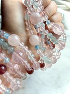 pastel mixed gemstone bracelet close-up with rose quartz focal bead and aquamarine accents, heart chakra crystal bracelet with natural variation