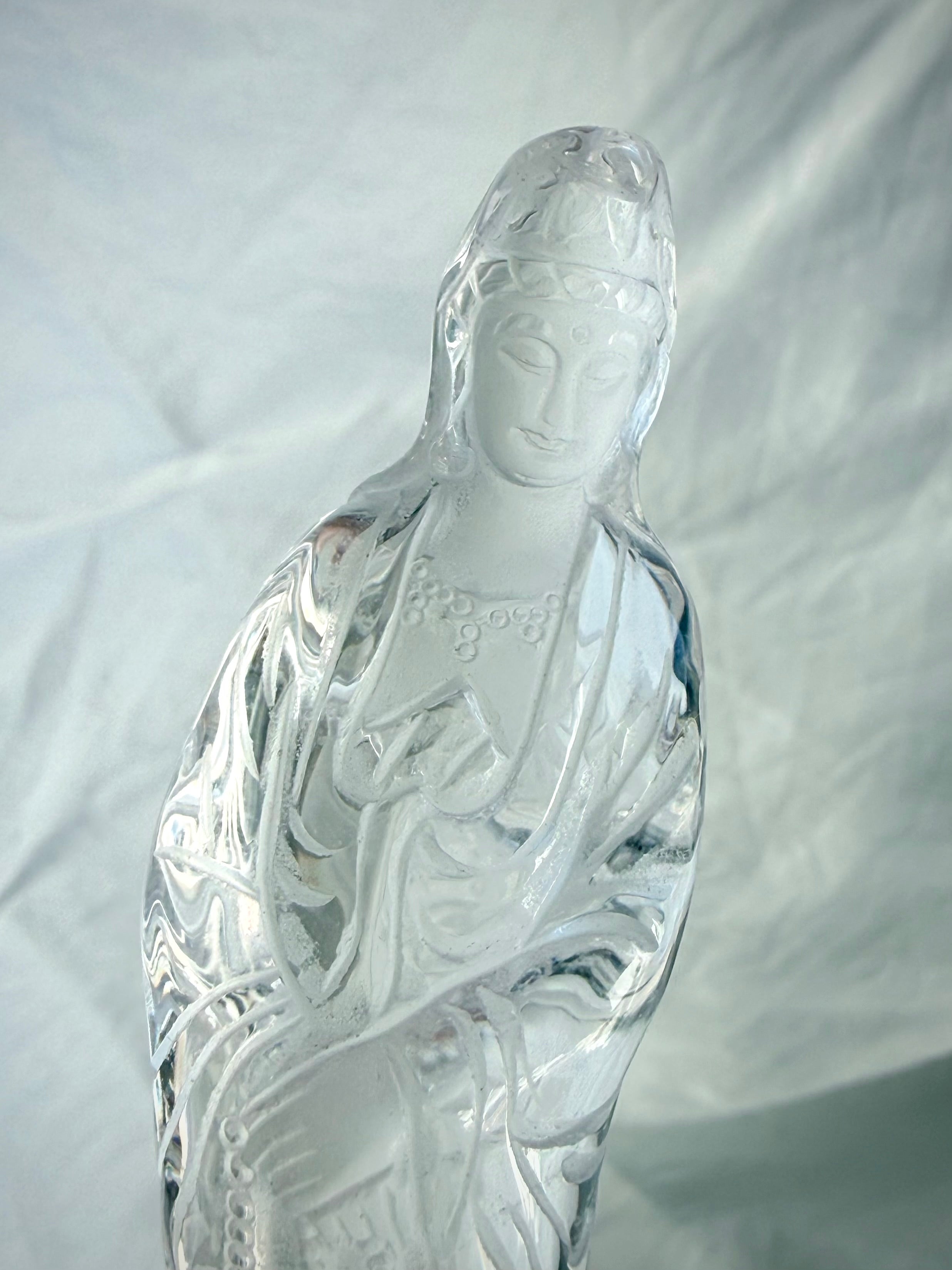 Close up of Collector-quality Quan Yin carving in natural Clear Quartz with graceful lines and peaceful expression
