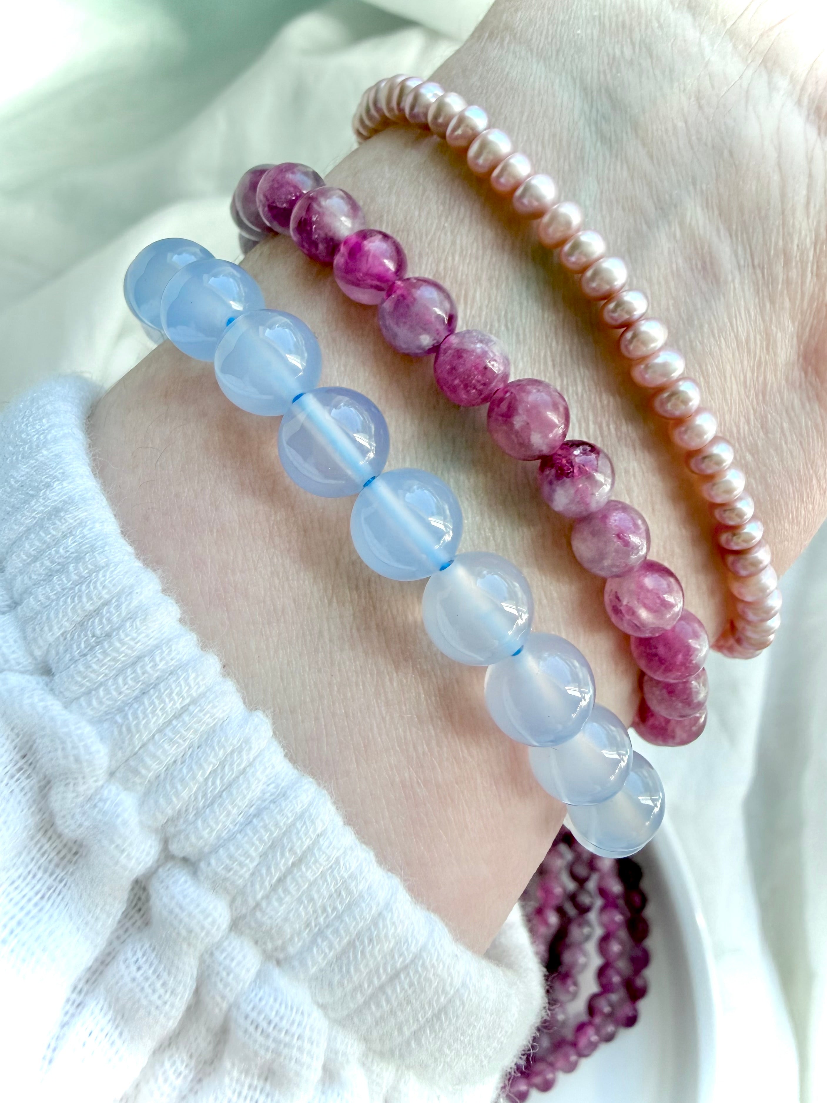 Pink Tourmaline bracelet stacked with Blue Chalcedony and Freshwater Pearl bracelets for elegant crystal jewelry layering inspiration