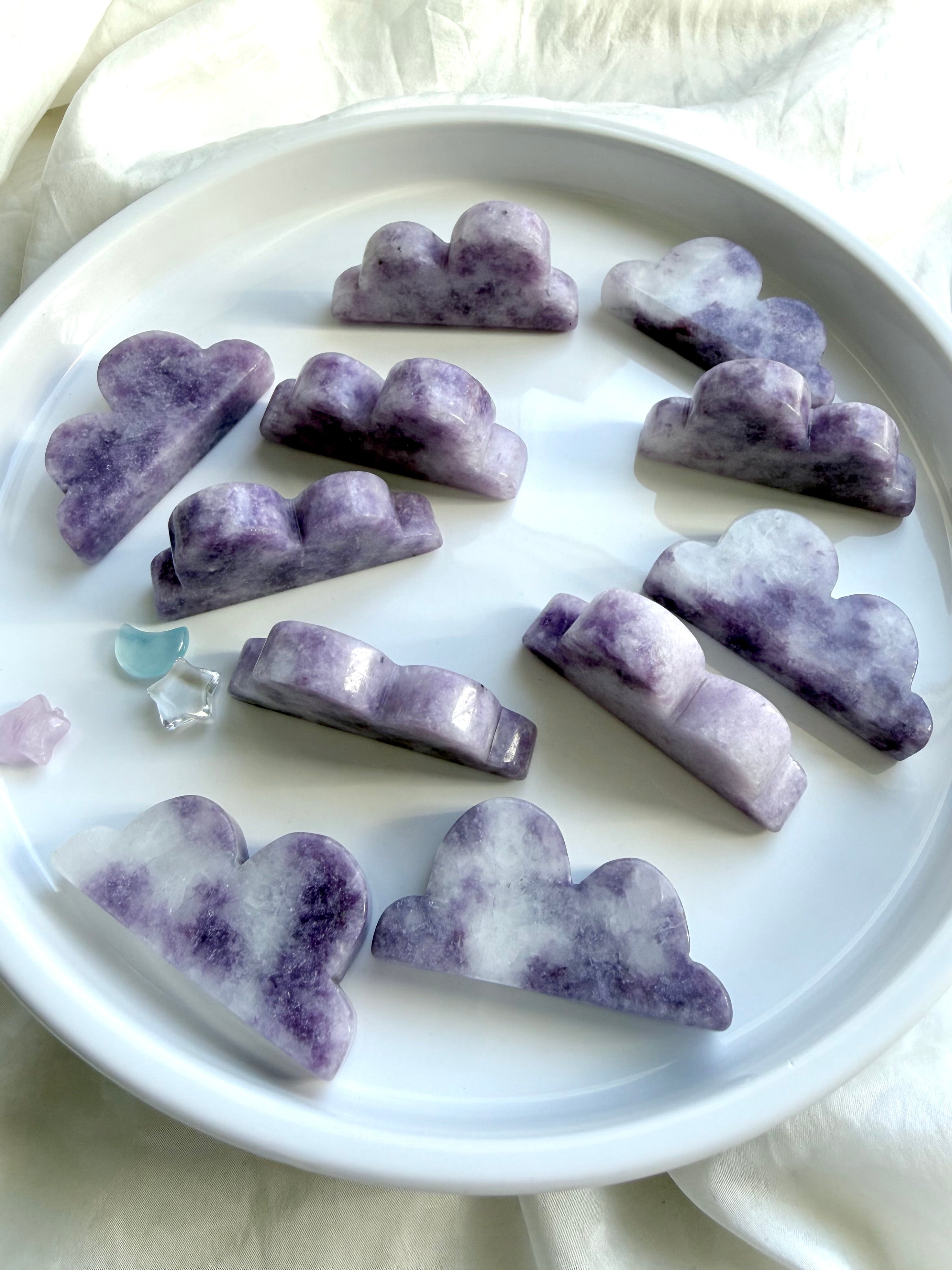 Lepidolite cloud carvings displayed standing upright showing natural lilac color variation and polished finish