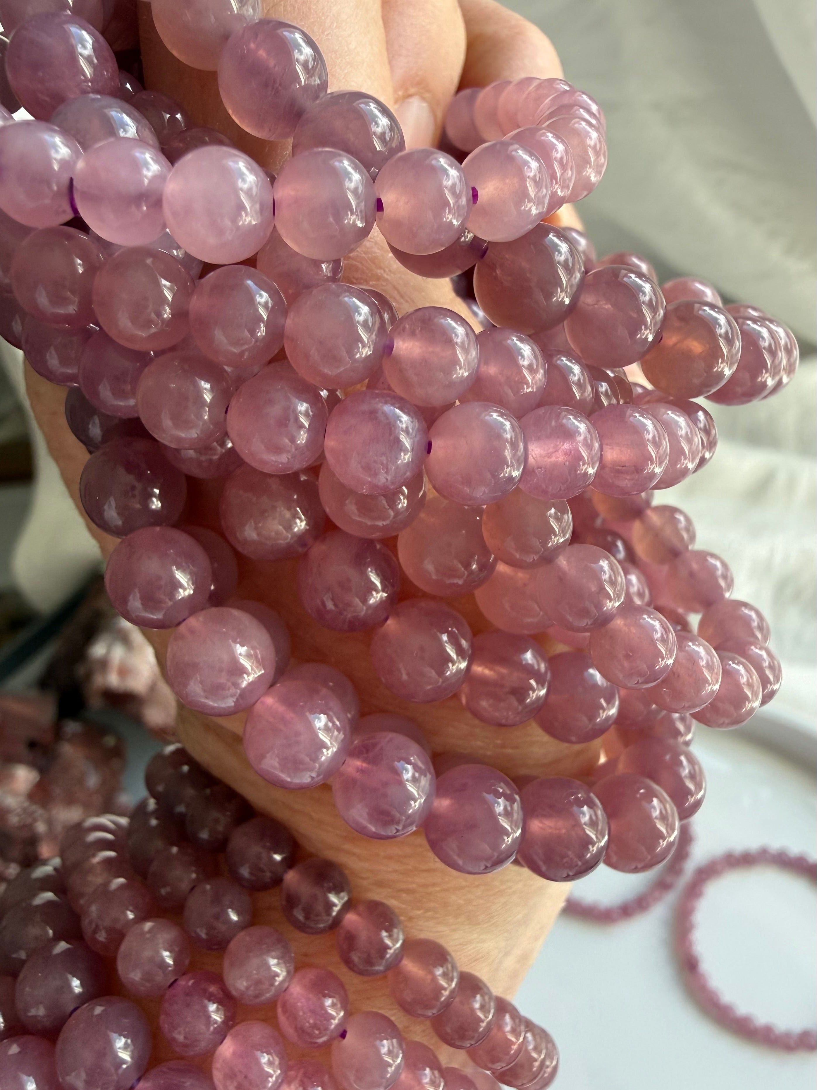 Lavender Rose Quartz Bracelet wrapped around wrist showing delicate pink and lavender gemstone beads from Madagascar