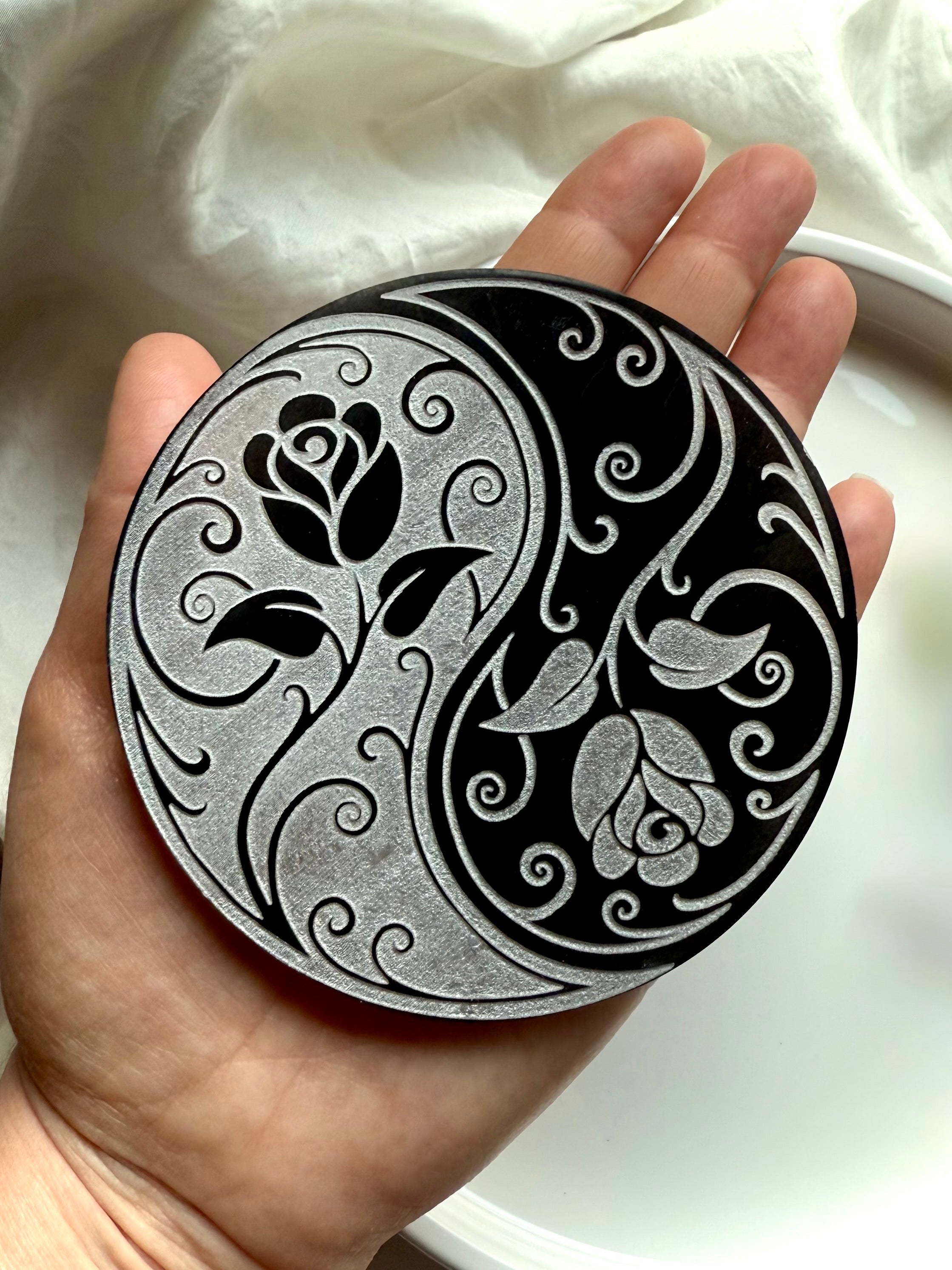 Selenite yin yang rose plate held in hand with dried flowers and crystals for altar or sacred space energy work