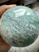 Rare Moss Agate crystal ball with natural druzy texture, organic patterns, and unique mineral details