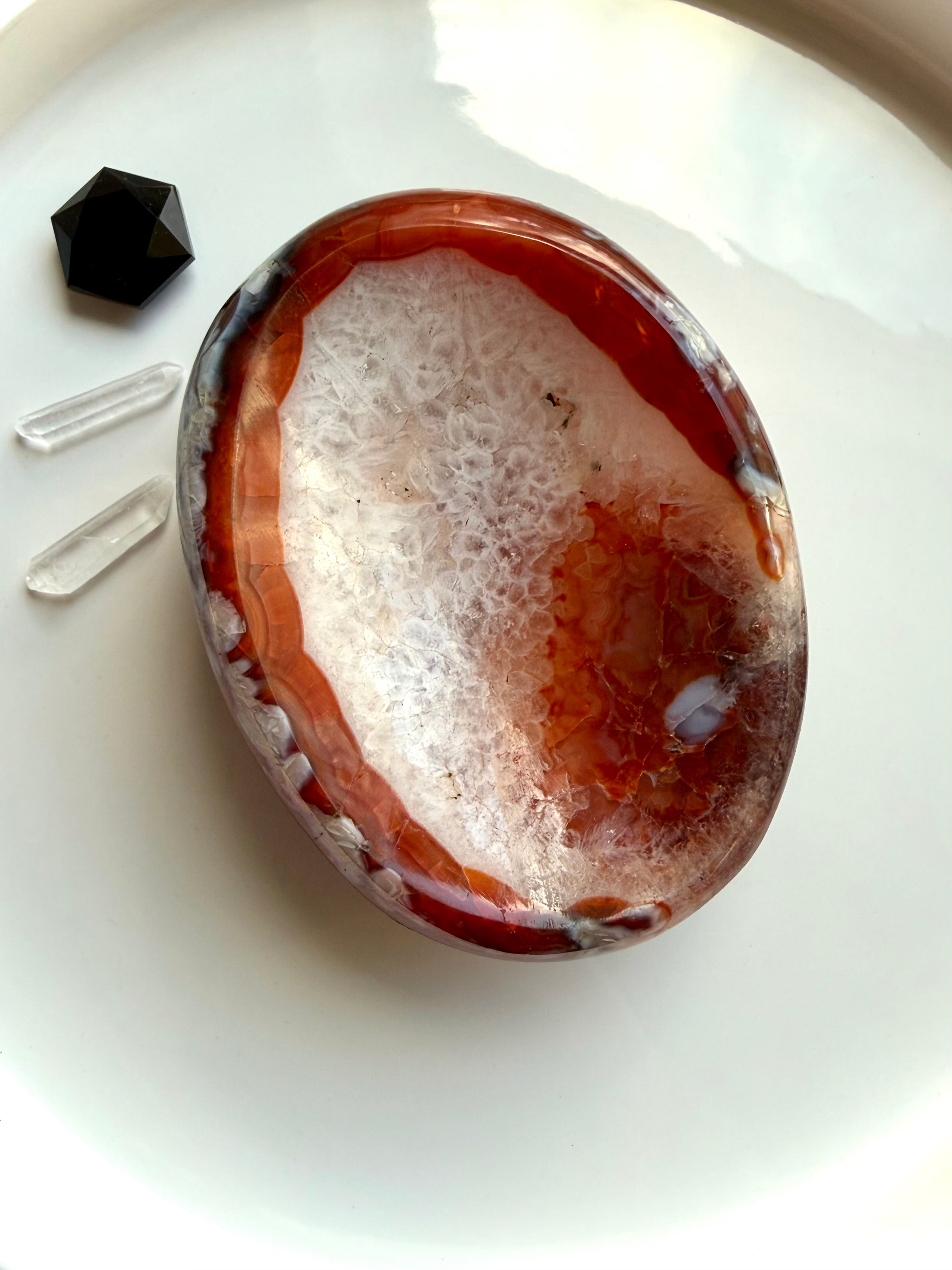 carnelian gemstone bowl with white quartz center used as ring dish and crystal display