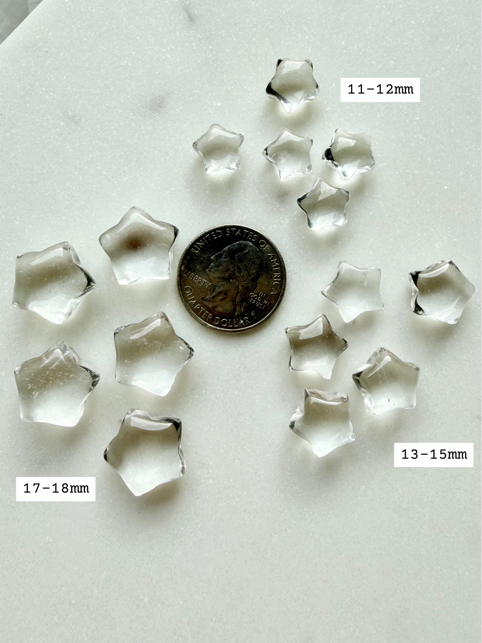 Mini Clear Quartz star carvings with a US quarter and size references for scale