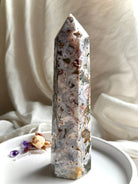 Standing Cosmic Ocean Jasper crystal point with polished faces, ocean-like patterns, and grounding earthy inclusions