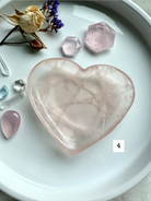 rose quartz heart bowl on white tray with dried flowers and polished crystals, heart chakra gemstone dish for love energy and metaphysical rituals