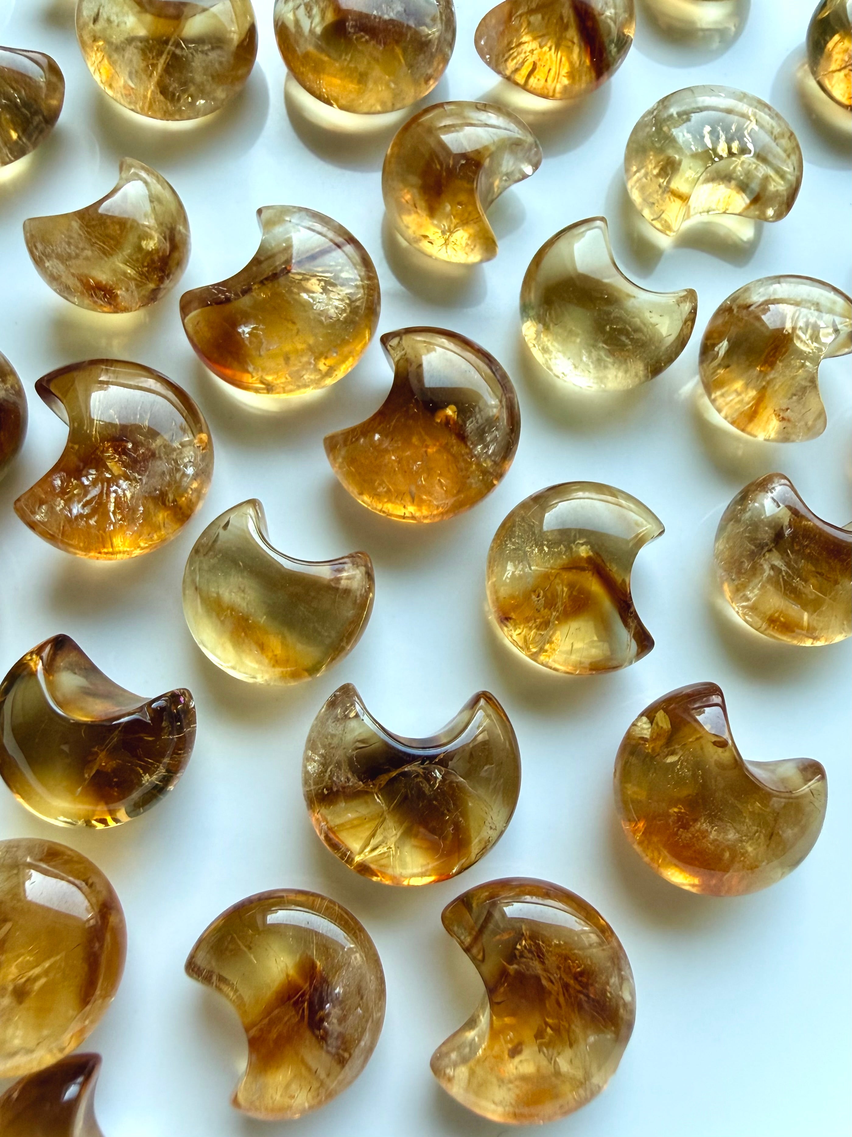 Polished Mini Citrine moons with luminous amber color, beautiful clarity and occasional phantom-like lines