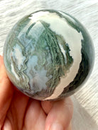 Polished Moss Agate crystal sphere with pale green dendritic inclusions and white agate