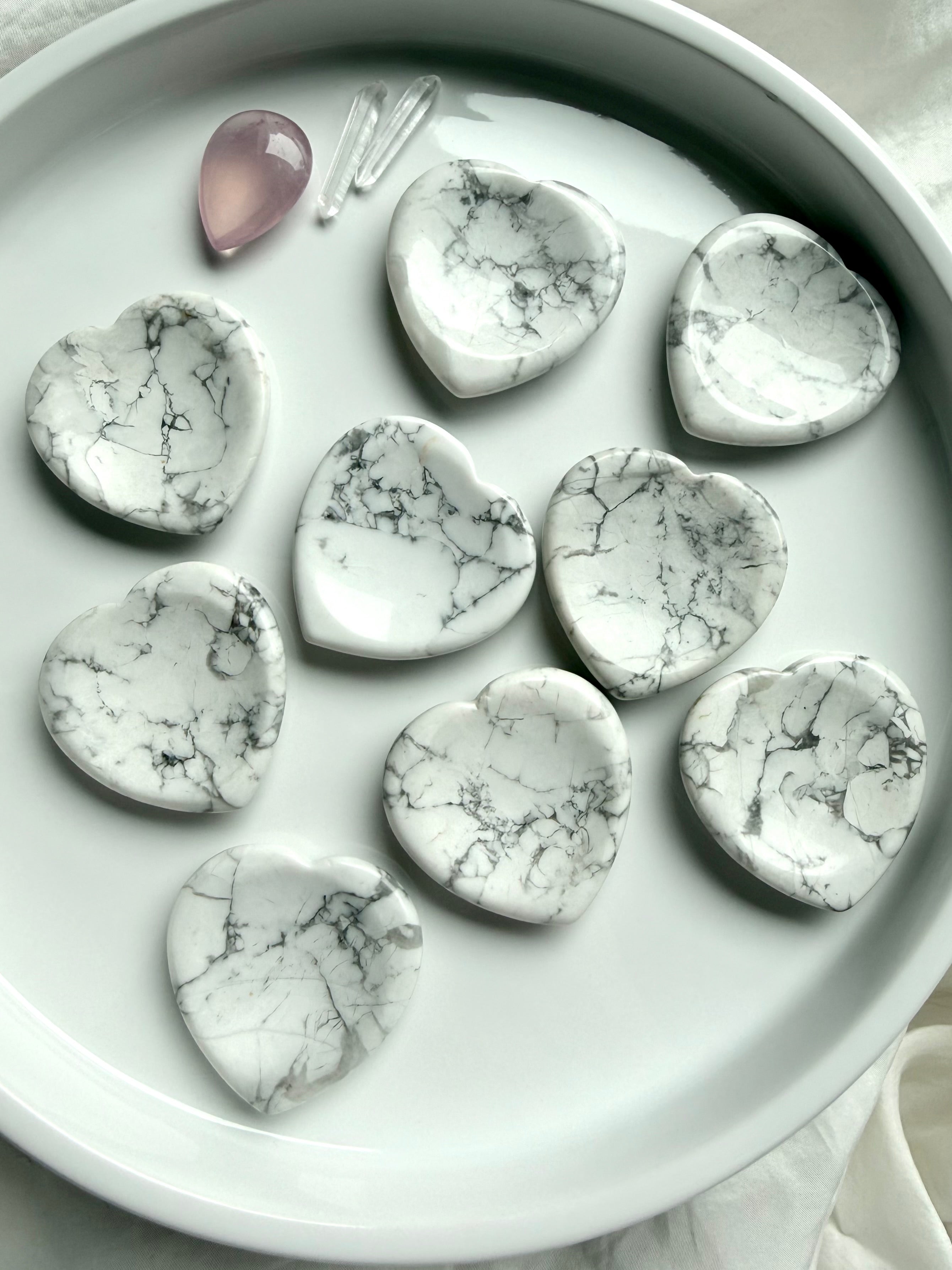 Howlite heart worry stones on white tray with natural gray veining polished thumb stones
