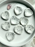Howlite heart worry stones on white tray with natural gray veining polished thumb stones