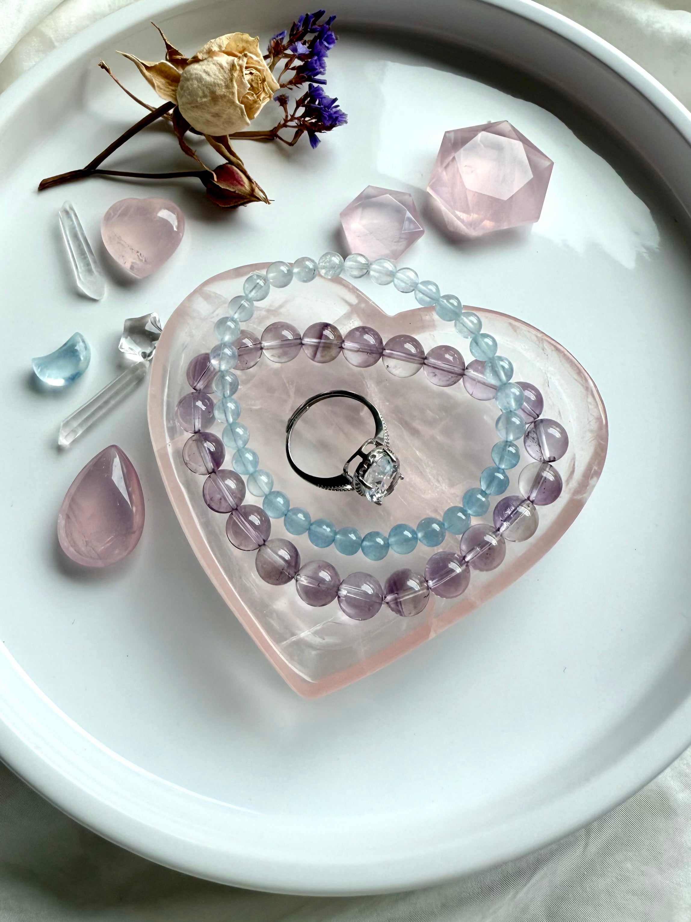 Rose Quartz heart bowl styled as a vanity jewelry dish with bracelets and ring, a giftable piece of metaphysical décor for love and healing.