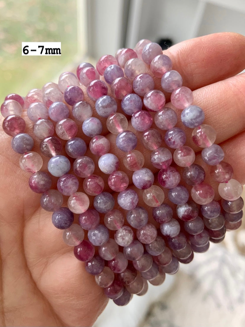 Unicorn Stone bracelets with 6–7mm beads — pink and purple tourmaline crystal jewelry shown close up for size, quality, and color reference.
