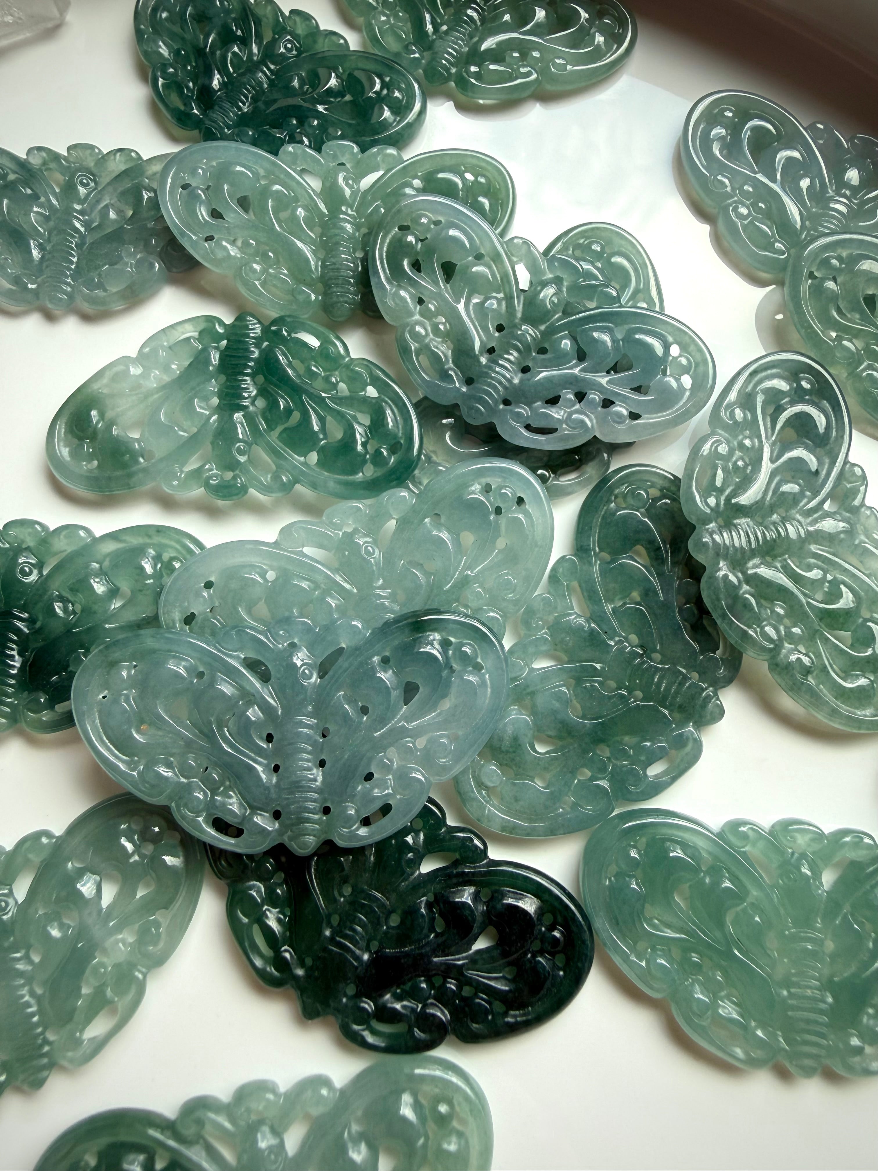 Assorted Blue Water Jade butterfly crystal carvings with natural color variation and translucency