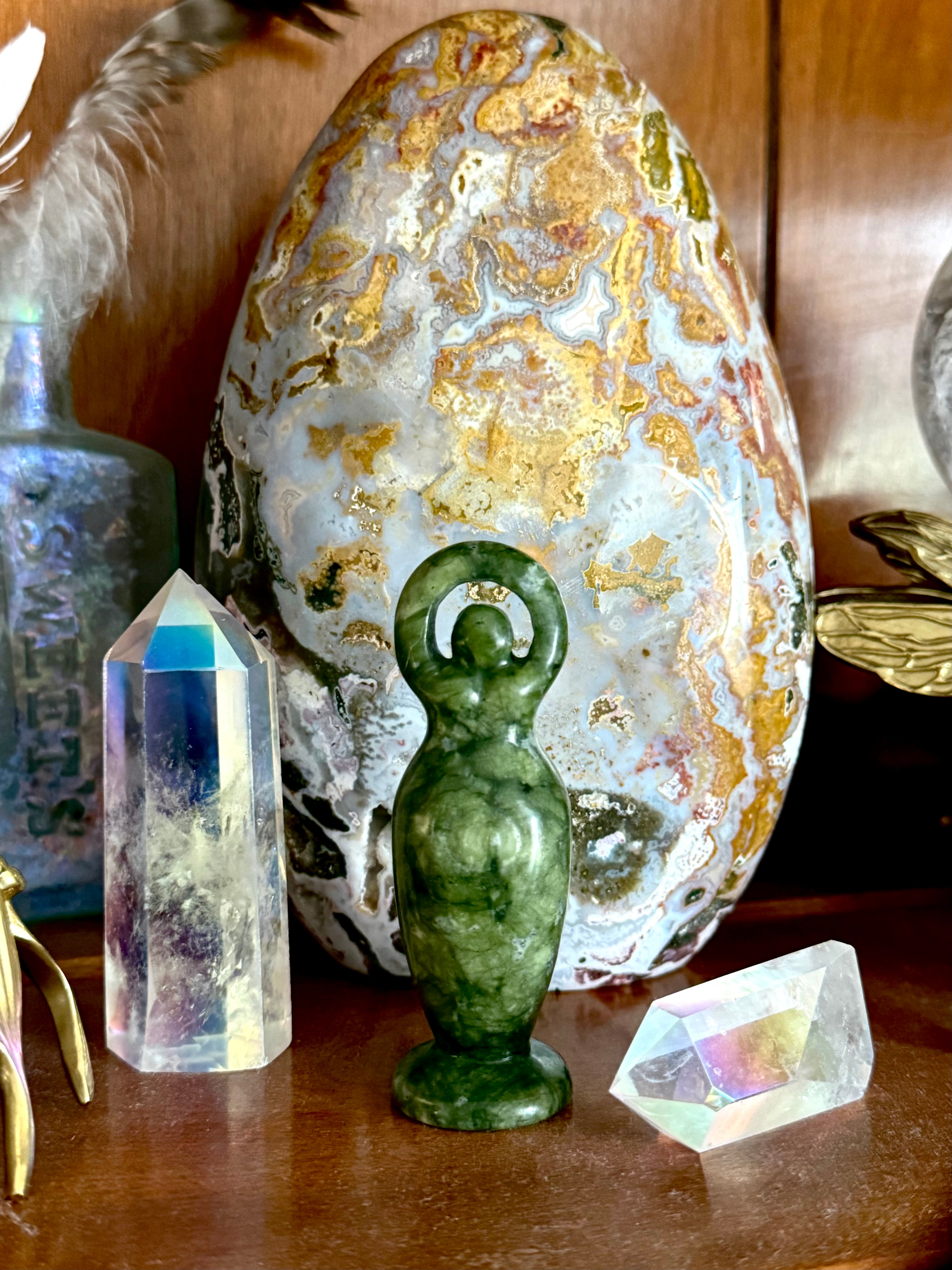 jade goddess figurine on crystal altar with aura quartz points sacred feminine decor for protection and harmony