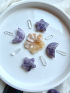 Lepidolite moon and star crystals with Flower Agate flower and Clear Quartz points arranged in a celestial crystal grid
