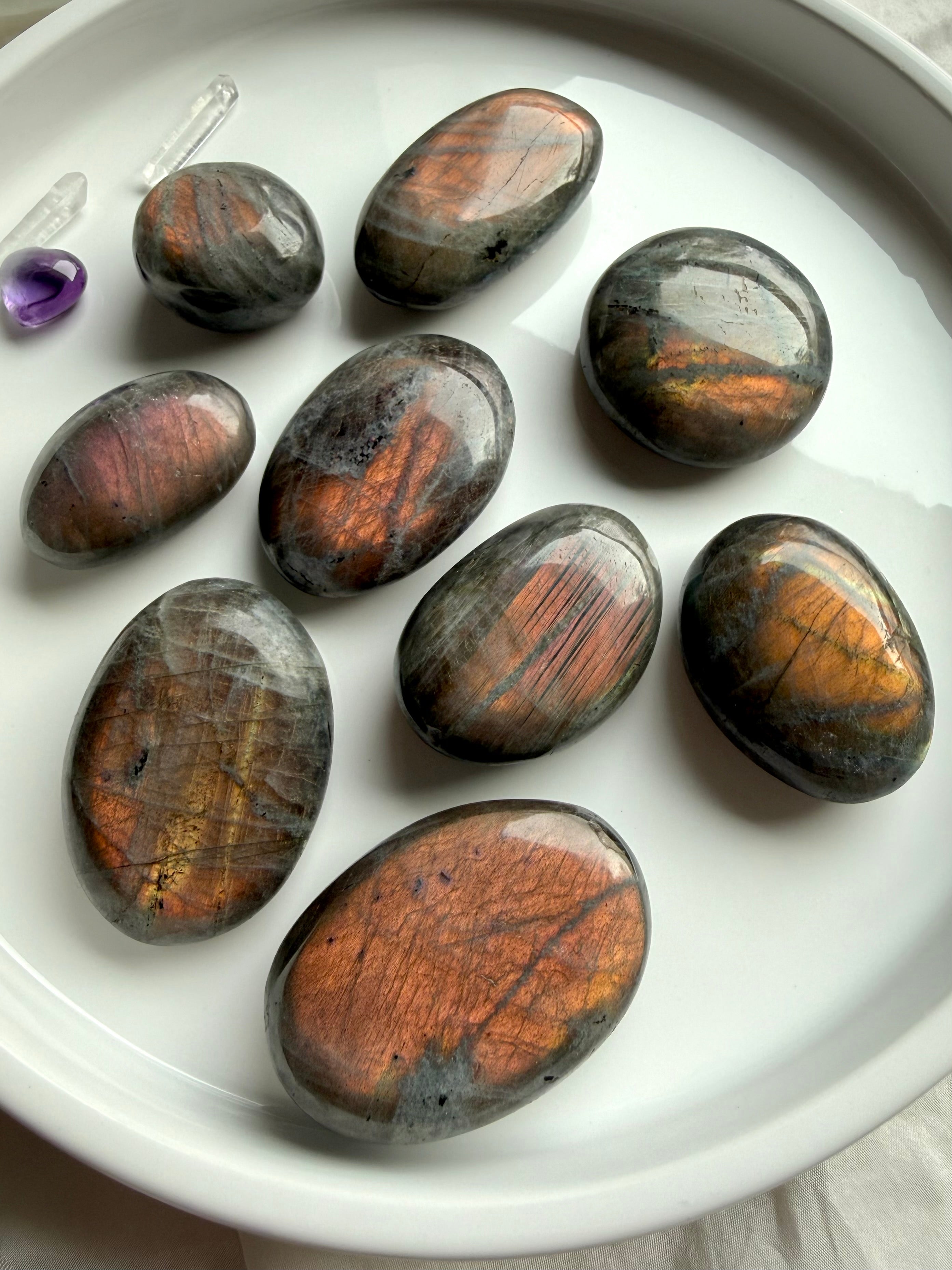 Sunset Labradorite palm stones with vibrant peach and golden flash in natural light