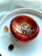 Carnelian bowl displayed with ring and crystals – gemstone dish for jewelry, altar, or crystal decor