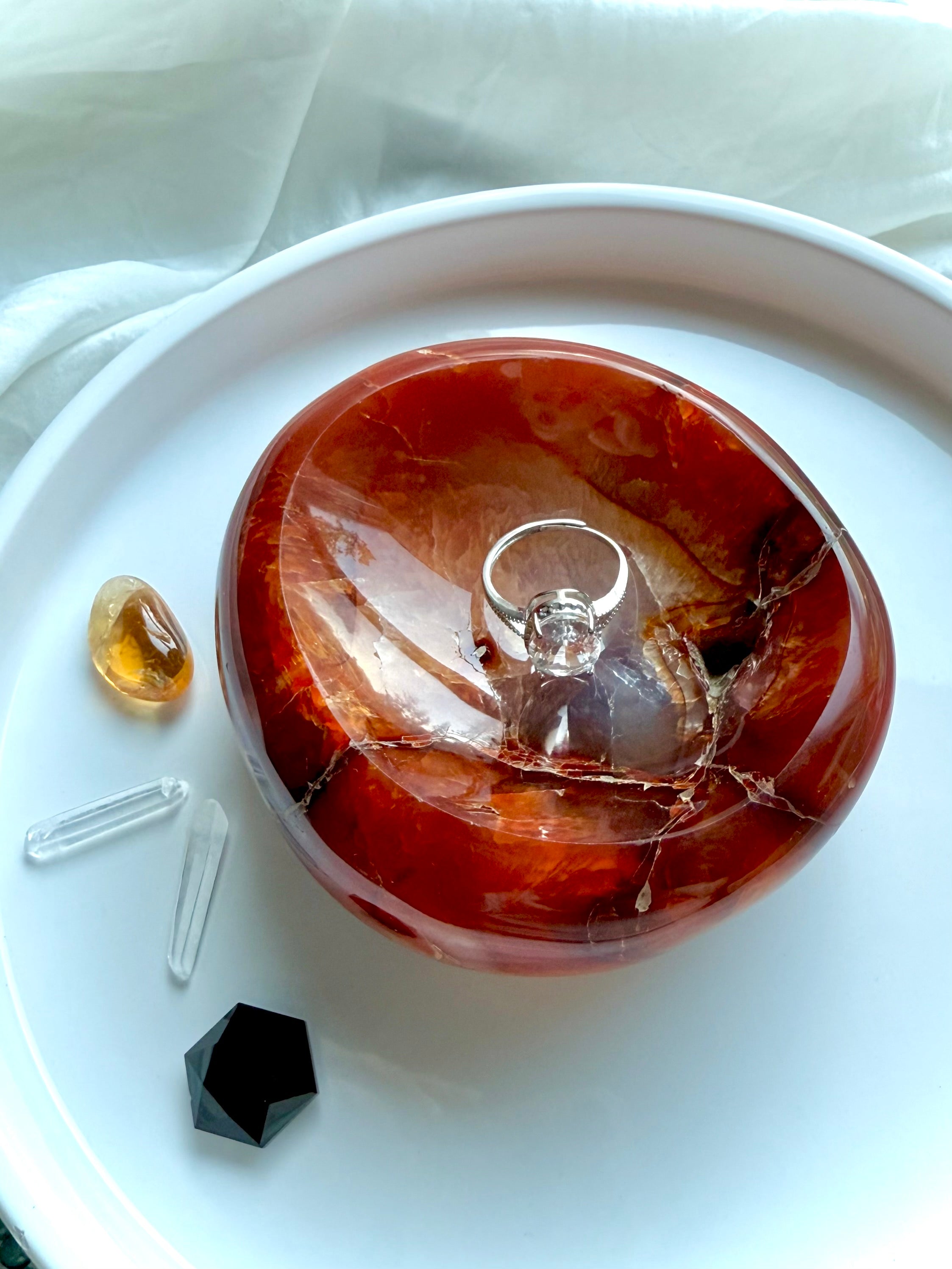 Carnelian bowl displayed with ring and crystals – gemstone dish for jewelry, altar, or crystal decor