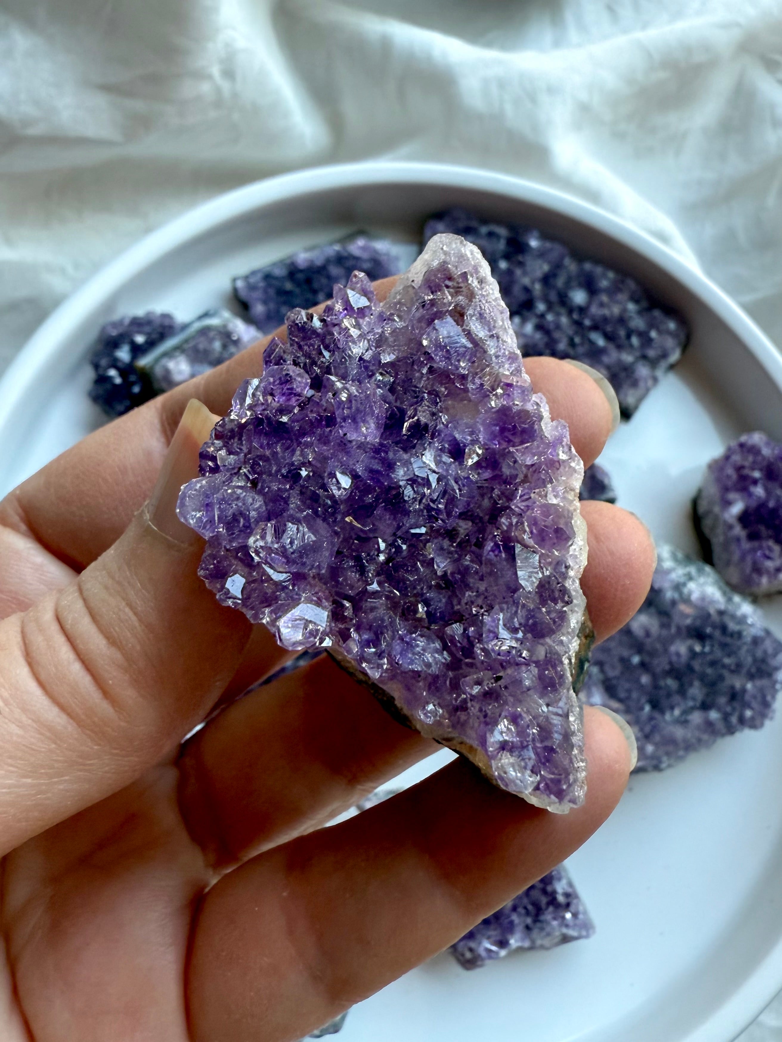 Small amethyst geode cluster with sparkling purple crystal points