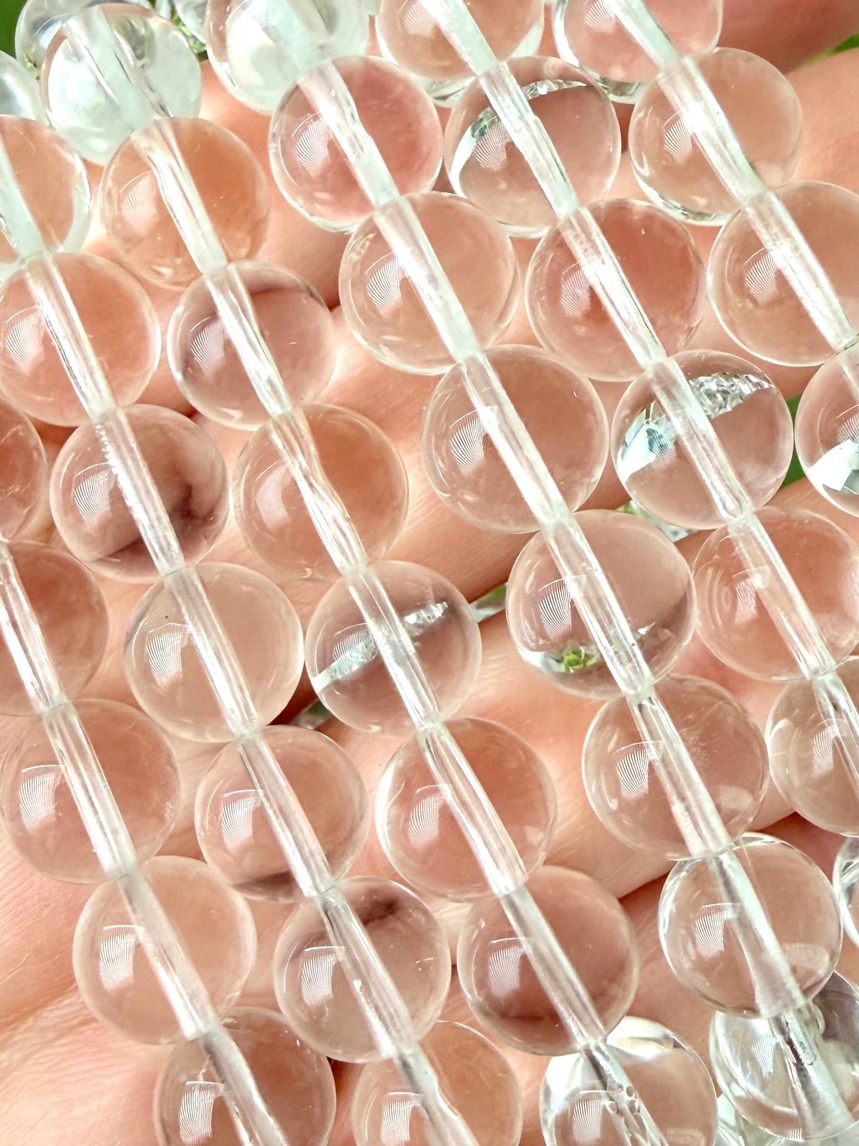 Close-up of Clear Quartz bracelet showing transparent polished crystal beads and natural clarity