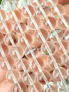 Close-up of Clear Quartz bracelet showing transparent polished crystal beads and natural clarity