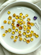 Mini Amber Star carvings reflecting light on white background – crystal stars for joy, empowerment, and chakra balance